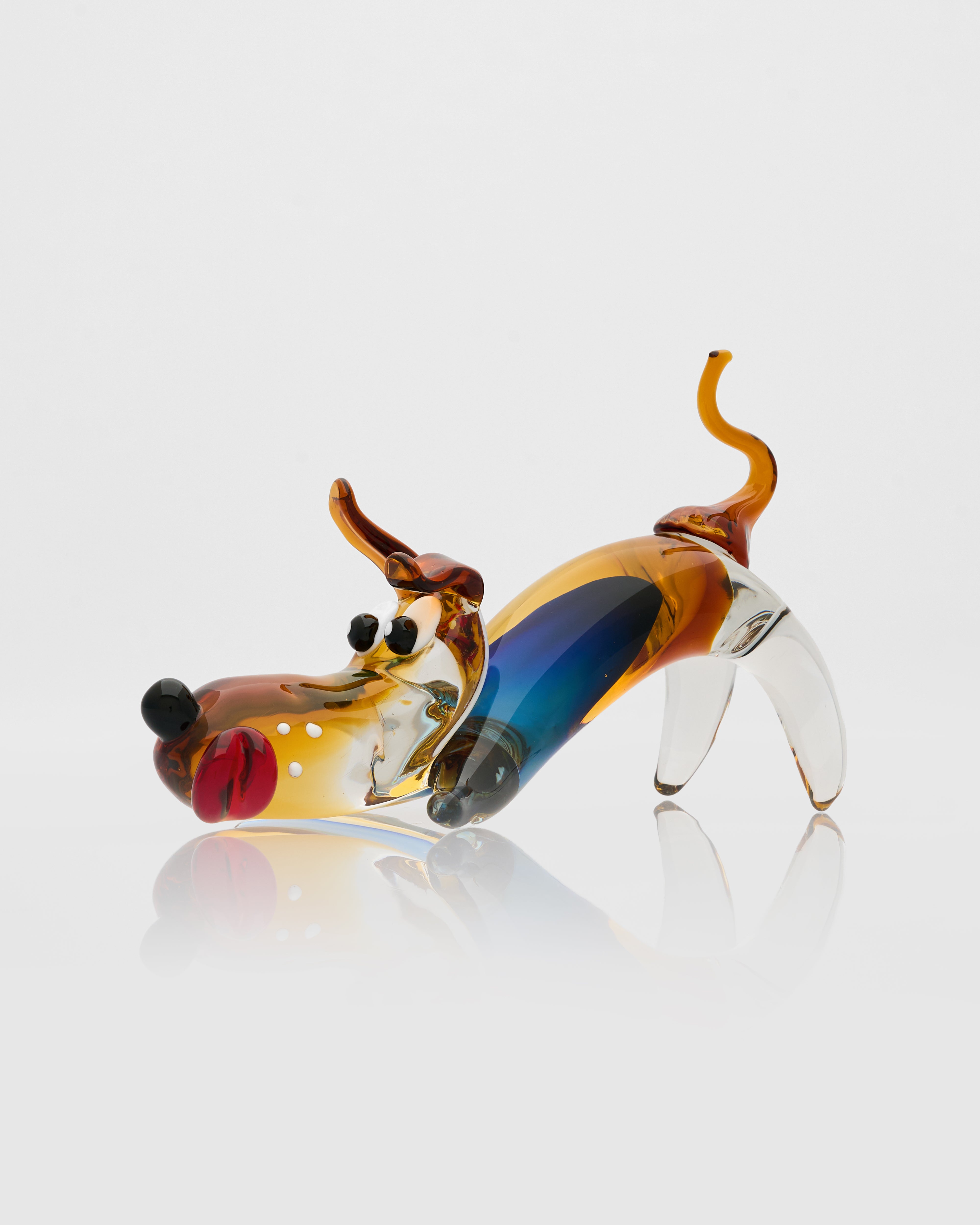 Glass sculpture of a dog on a white background