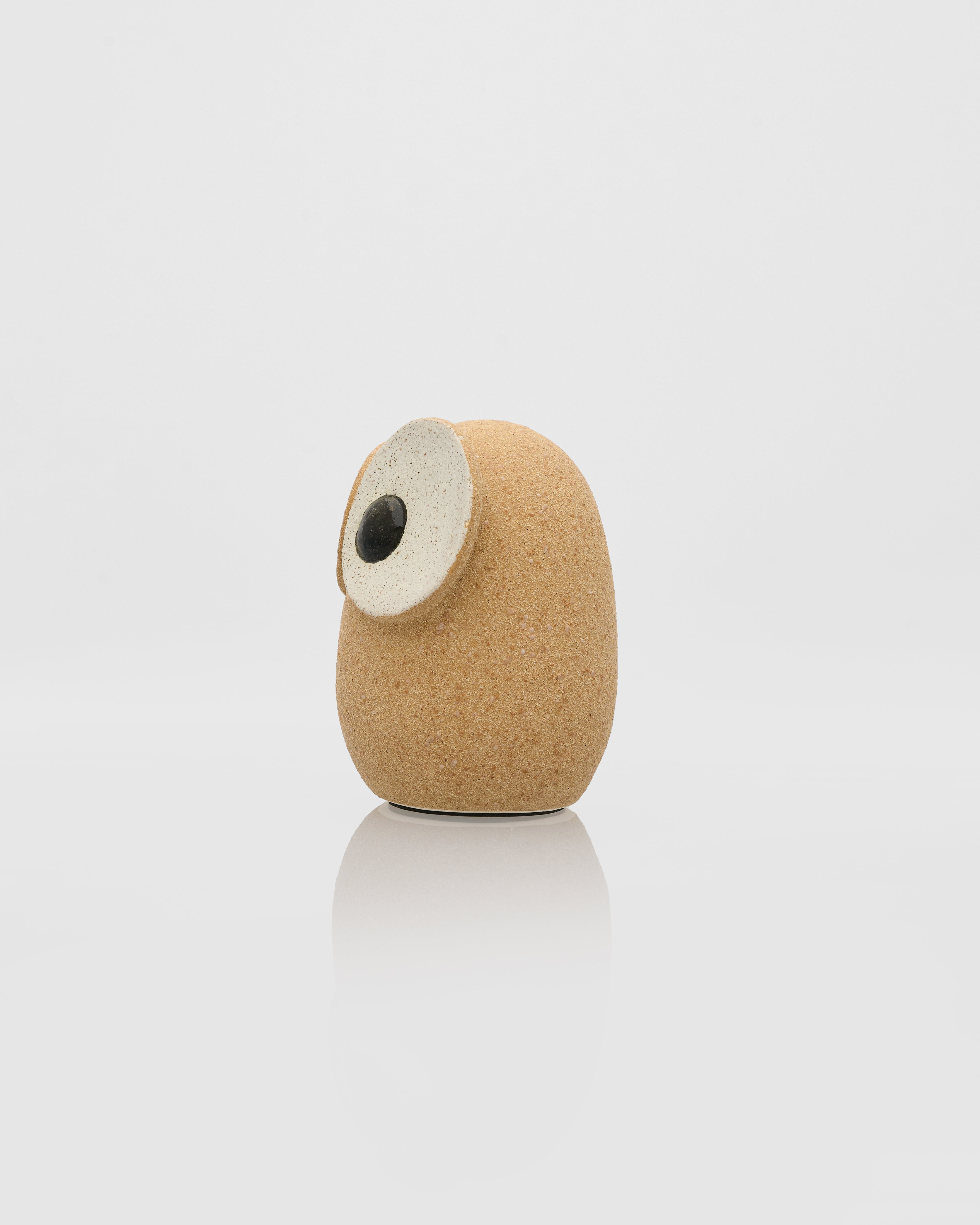 Cylindrical object with cork-like texture and black center on a white background