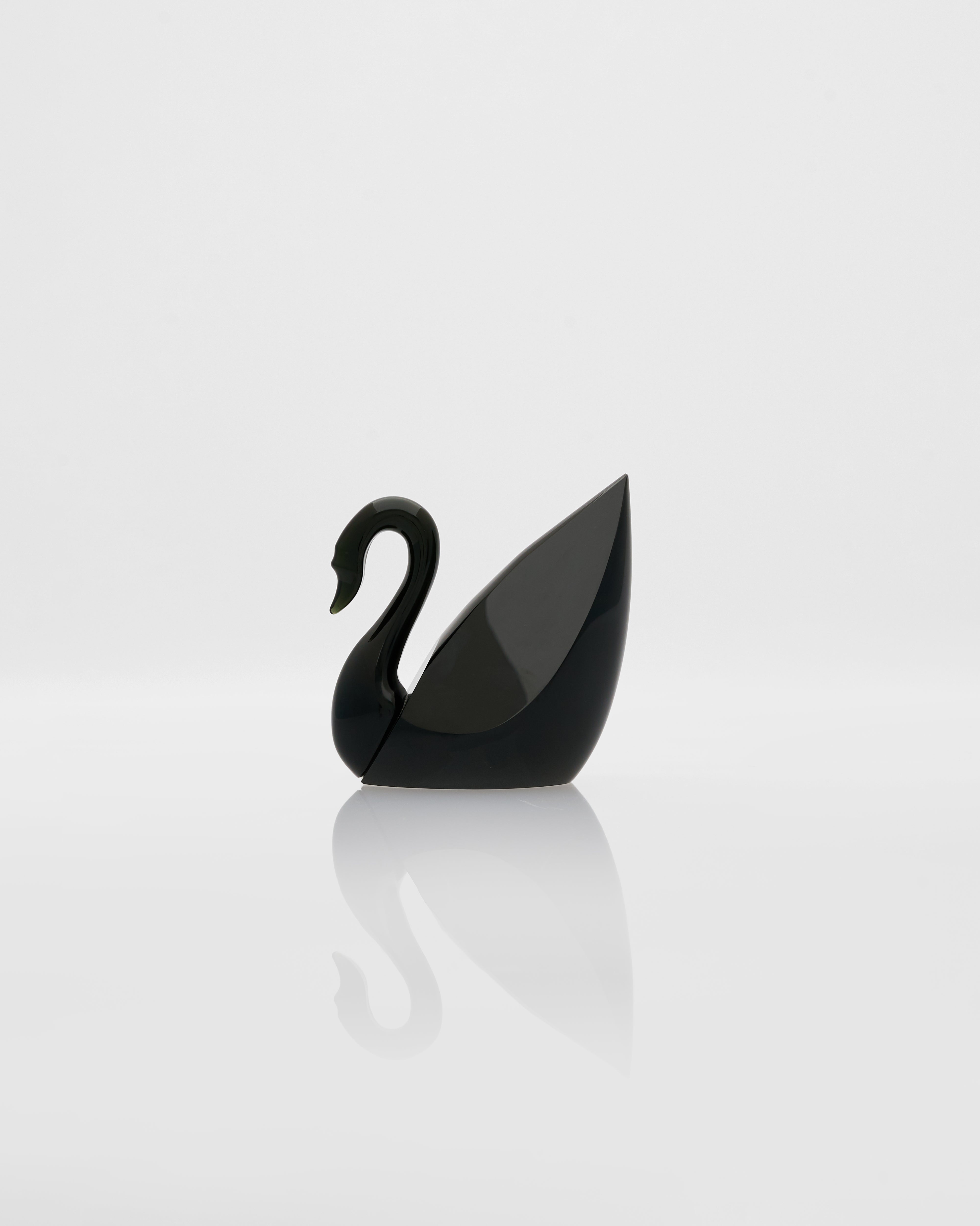 Black swan-shaped object on a white background