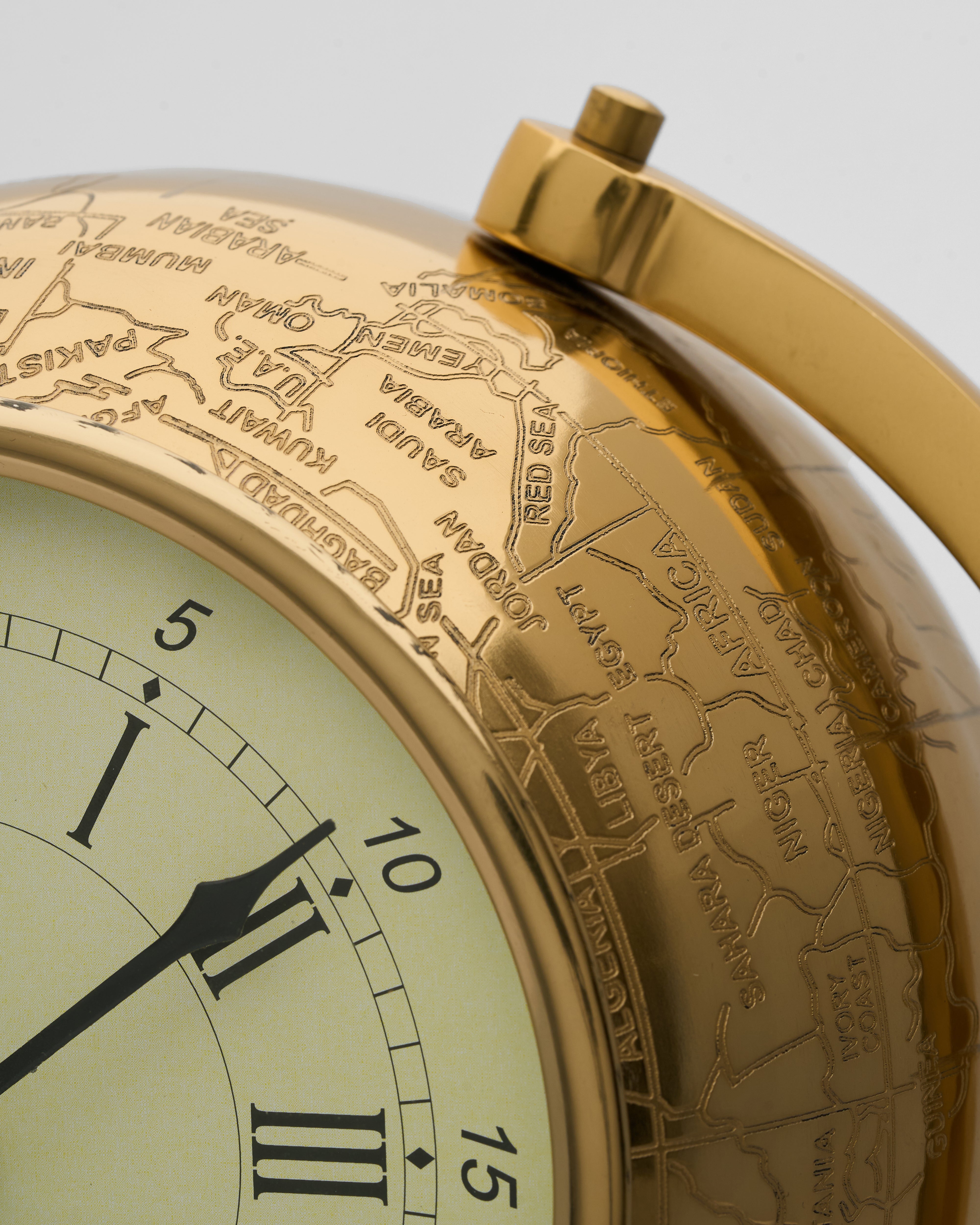 Close-up of vintage globe inspired table clock revealing fine textures and high-quality material craftsmanship
