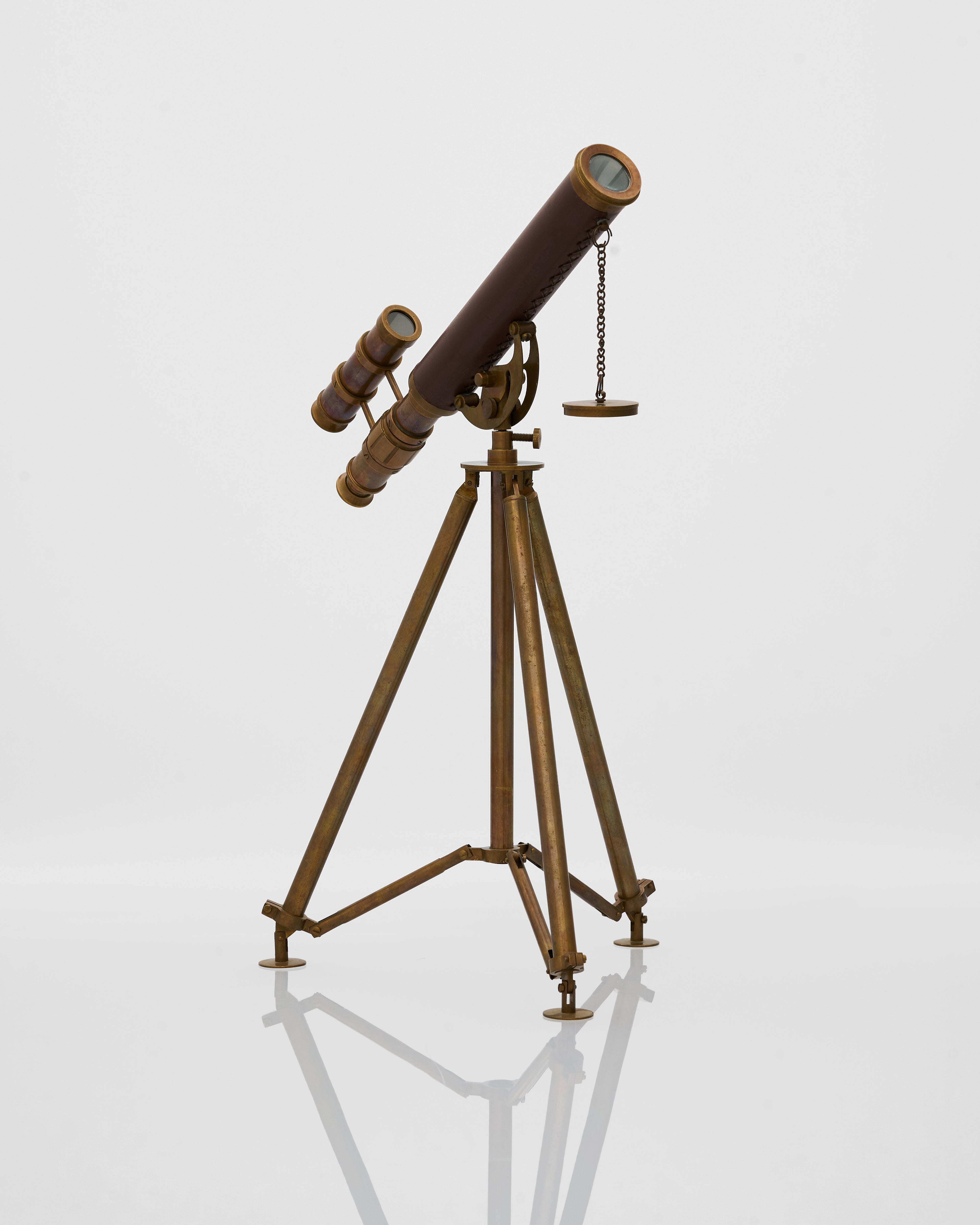 Vintage-style telescope on a tripod against a white background