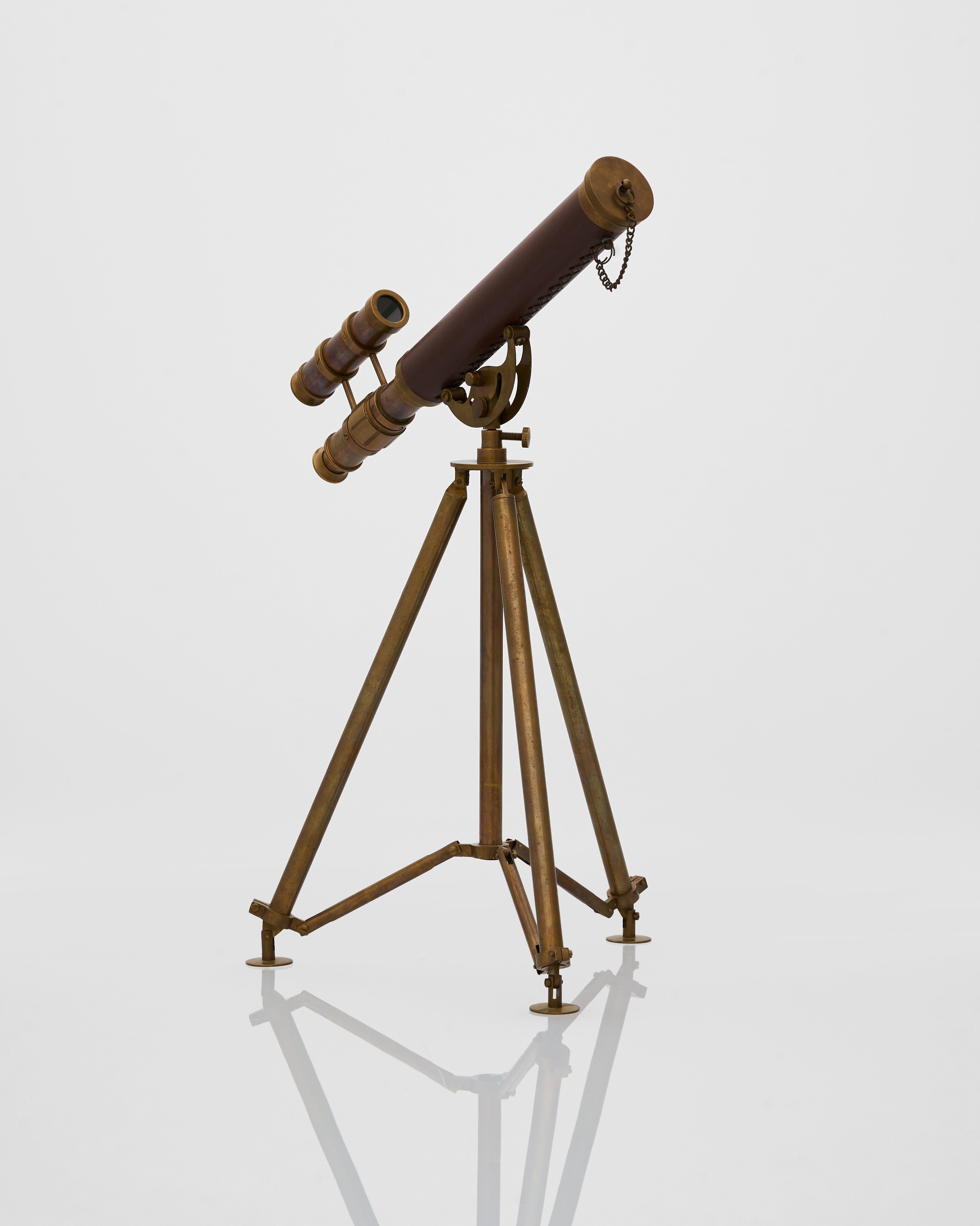 Vintage telescope on a stand against a white background