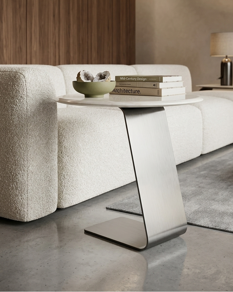 Modern living room with a white sofa, side table, and decor items.